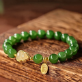 Mira green bead bracelet on wood with gold heart and charm